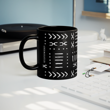 black african pattern coffee mug sitting on a table near a record player