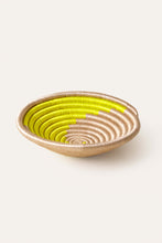 Woven african basket with neon green yellow spiral swirl pattern 