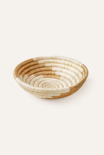 Woven storage basket in neutral colors on a white background