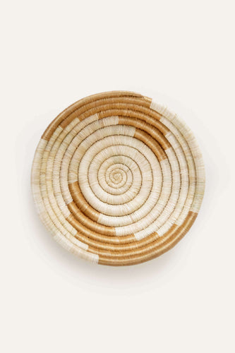 Woven basket with spiral circle pattern on a white background