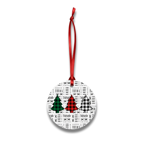 Round Christmas ornament with tree designs on a white background