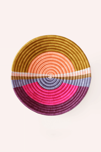 Colorful woven basket with sunset circular pattern on a white background