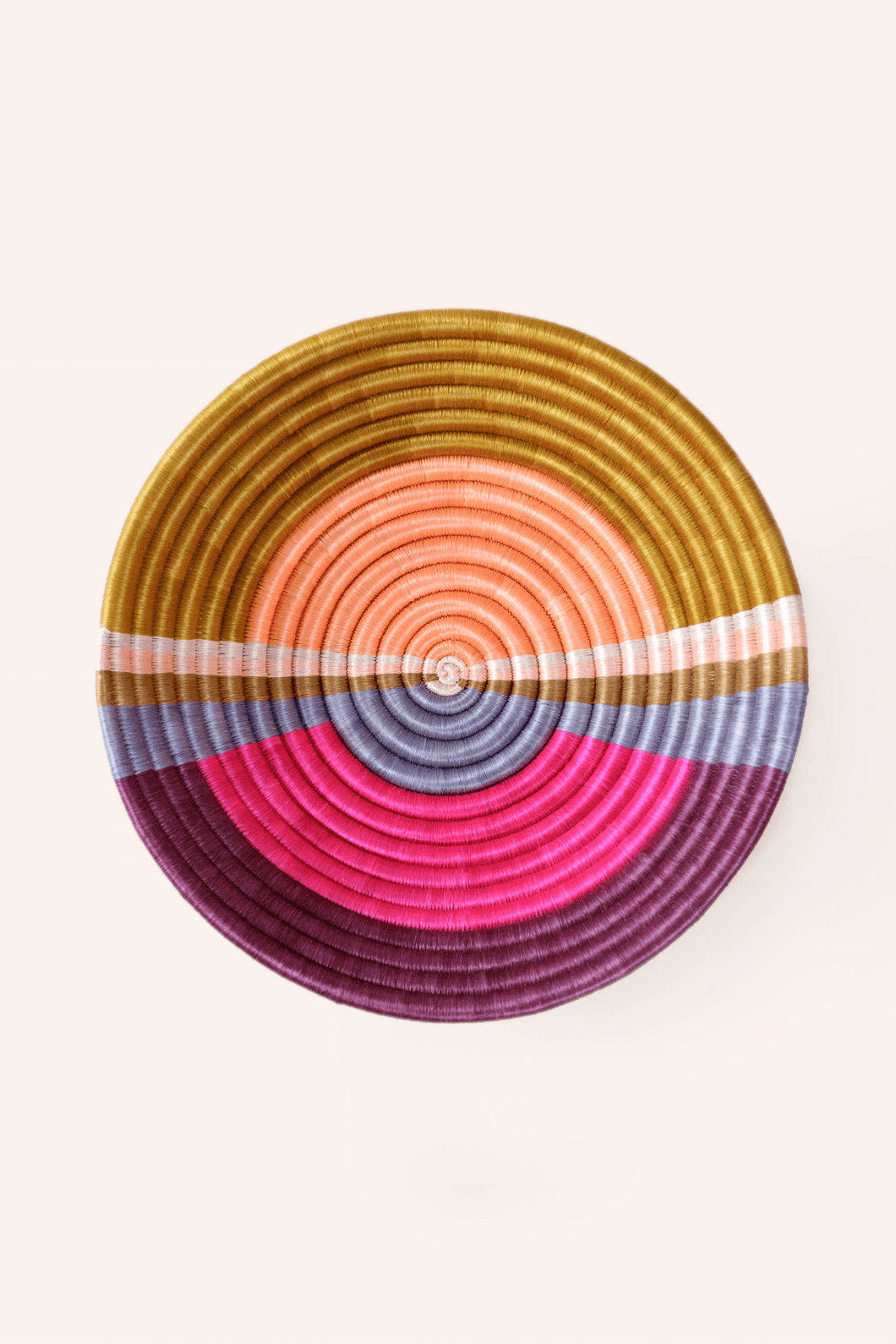 Colorful woven basket with sunset circular pattern on a white background