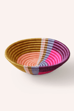 Woven african basket with multicolored pattern on a white background