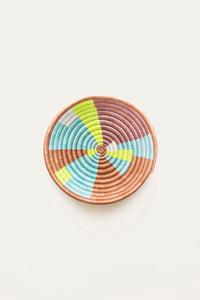 Woven basket with neon multicolored pattern on a light background