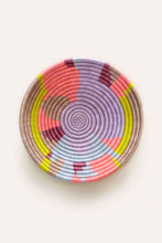 Neon colors woven basket with abstract circle pattern on a white background