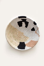 handmade woven basket with black, white and brown pattern on a white background