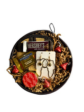 Round valentines day gift basket with chocolates, Africa earrings, and a coin purse.