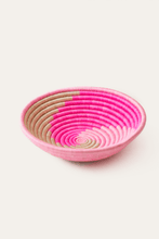 Pink woven african basket on a white background