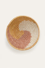 Beige Woven basket with spiral circle pattern on a light background