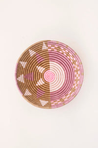 Woven basket with pink and brown pattern on a white background