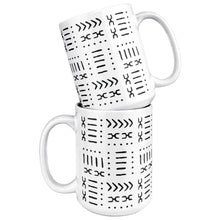 two white and black African pattern coffee mugs stacked