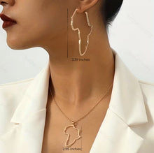 Gold necklaces with Africa map design worn by a person, shown against a neutral background.