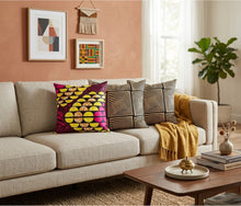 Living room with a beige sofa, colorful pillows, and a wooden coffee table.