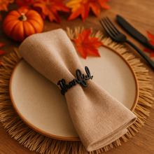Napkin with 'Thankful' ring on a plate with autumn decorations