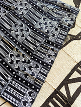 Black and white patterned fabric on a stone surface