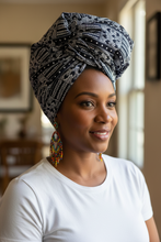 Woman wearing a black white african pattern head wrap.