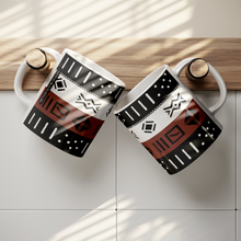 two African pattern coffee mugs hung up on hooks