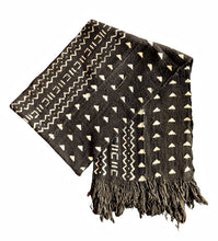 A black woven scarf with cream geometric patterns and fringed edges, displayed on a solid white background.