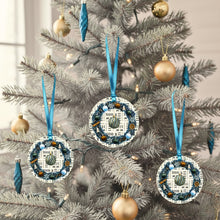 blue Christmas ornaments with blue ribbons on a white tree