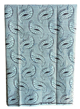 blue african print fabric folded on a white background