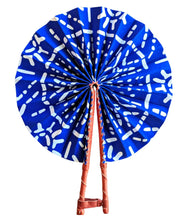 Blue and white patterned fan with wooden handle on a white background