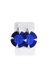 Blue beaded earrings on a white card with a white background