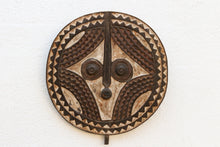 Decorative african wooden mask with intricate patterns on a white background
