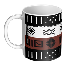 A white ceramic mug featuring a bold geometric pattern with horizontal bands of black, white, and rust brown, decorated with tribal-style symbols.