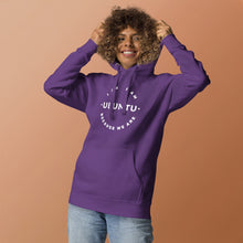 Person wearing a purple hoodie with text on a brown background