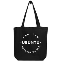Black tote bag with 'I AM I AM UBUNTU BECAUSE WE ARE' text on a white background