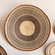 Woven basket with geometric pattern on a light background