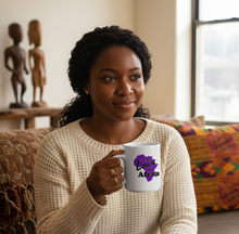Woman holding a mug with a purple Africa design in a living room.