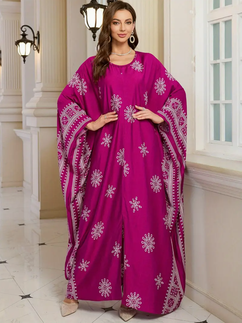 Woman wearing a vibrant pink dress with white patterns in an elegant interior setting.