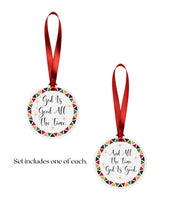 Two round Christmas ornaments with red ribbons on a white background.