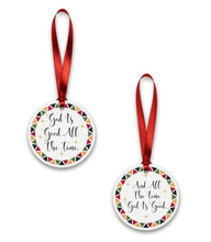Two circular ornaments with red ribbons on a white background