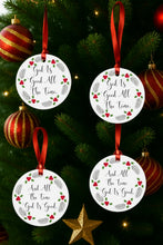 Four circular ornaments with text hanging on a Christmas tree.