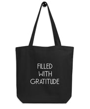 black totebag with a gratitude phrase on it
