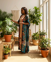 african american woman wearing a silky kaftan in her plant room