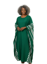 Woman wearing a green dress with white patterns on a white background
