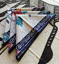 Colorful fabric napkins with patterns on a textured surface