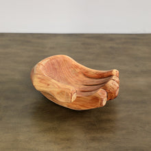 Wooden bowl with a natural, curved design on a brown surface