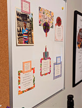 Framed artwork on a white board with decorative elements