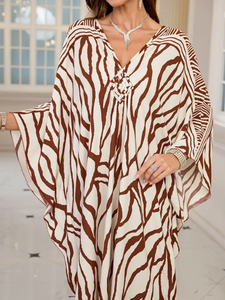 Woman wearing a zebra print dress with a blurred background