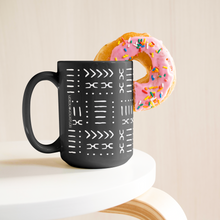 15 oz coffee mug with African pattern next to a donut