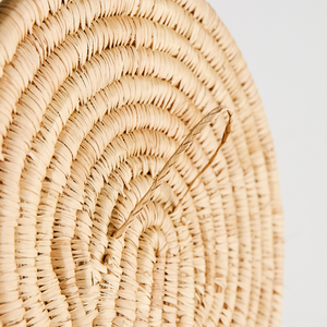 Close-up of a woven wall art with display loop on the back 