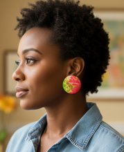 Woman wearing colorful earrings in a room with decor