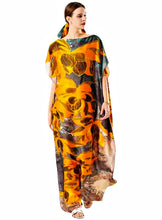 Woman wearing a colorful floral kaftan dress on a white background