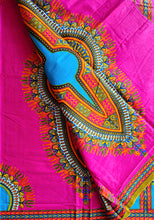 Colorful African fabric with intricate patterns on a pink background