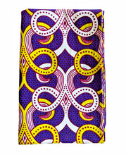 Colorful purple african fabric head wrap with intricate pattern on a white background